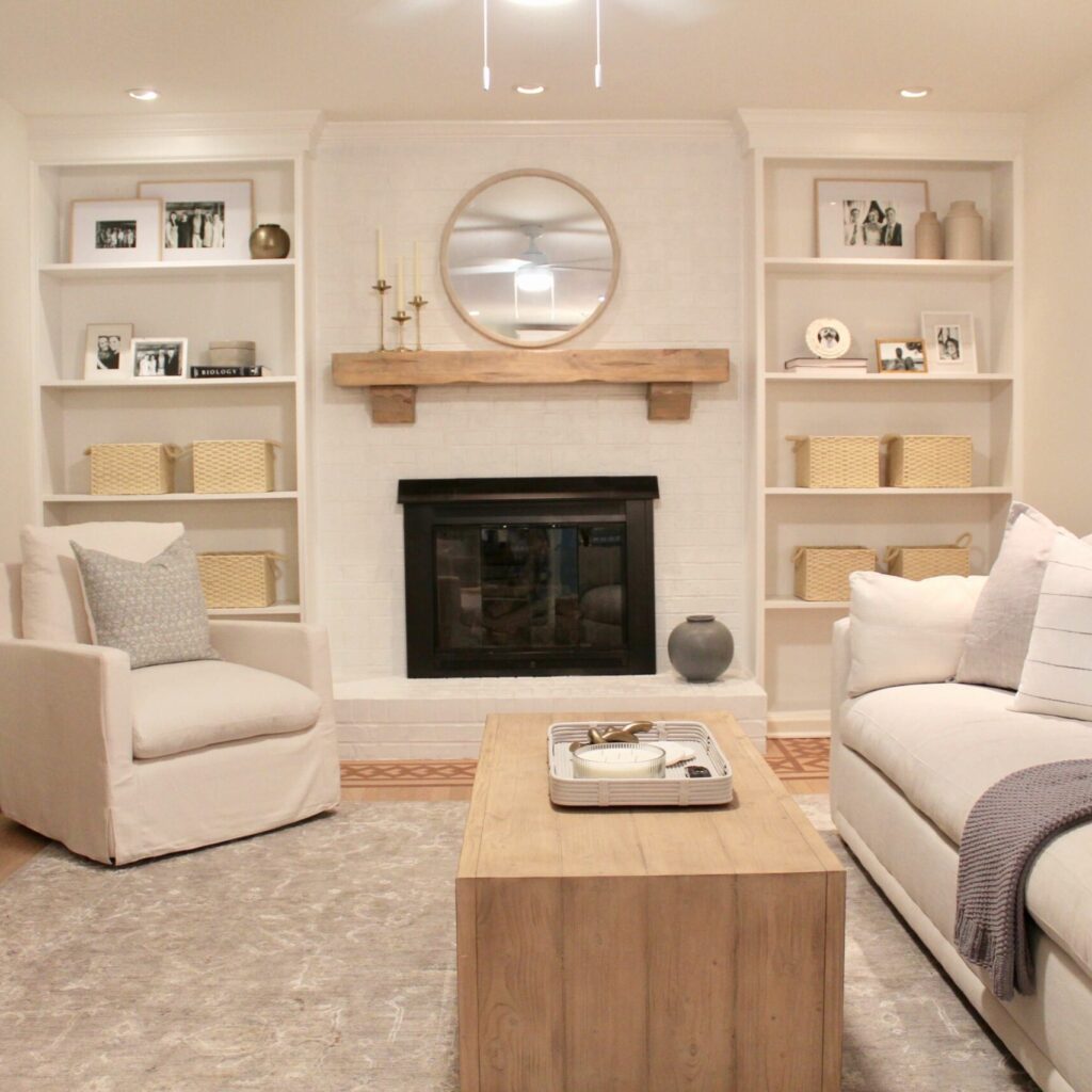 clean neutral living room with fireplace and two couches designed by The Highpoint House