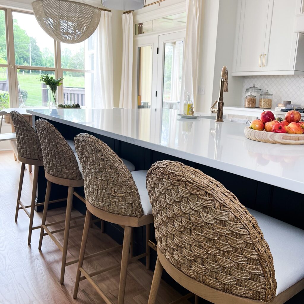 Kitchen island with 2 wooden chairs designed by the Highpoint house