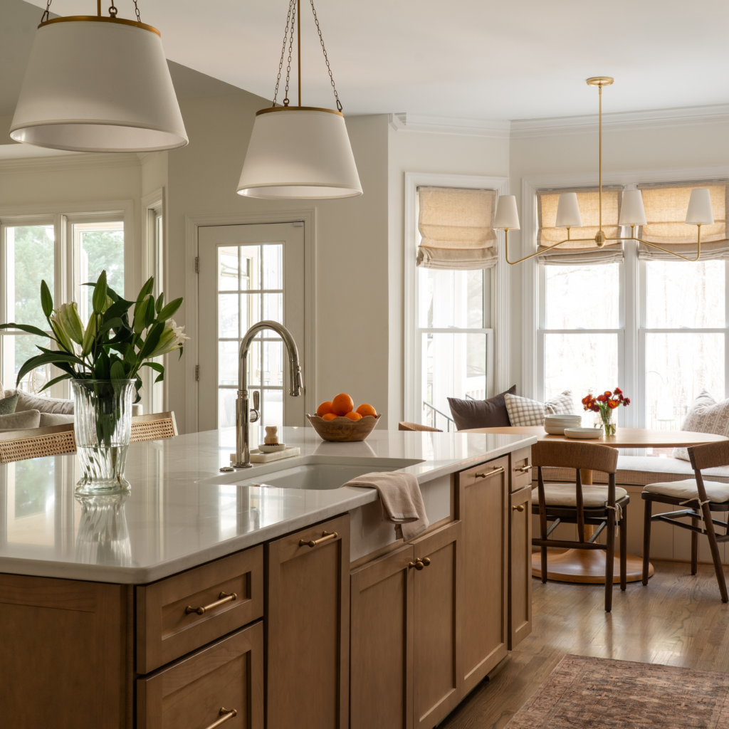 modern kitchen with white counters and wood cabinets