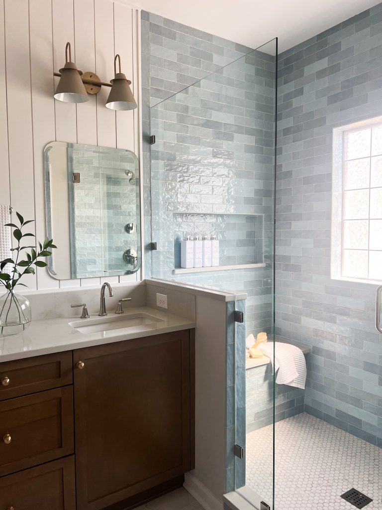 a bathroom with a glass shower door