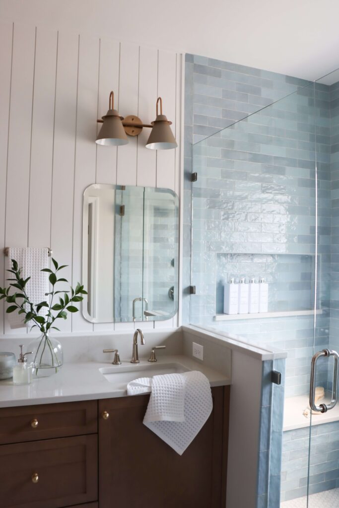 a bathroom with a glass shower and sink