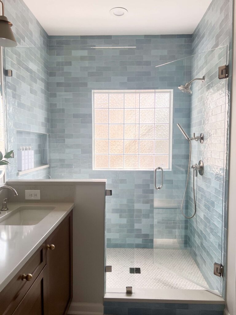 a bathroom with a glass shower and sink