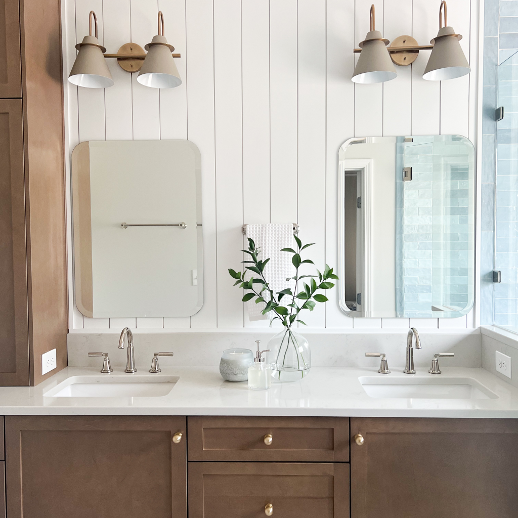 a bathroom with two sinks and a mirror