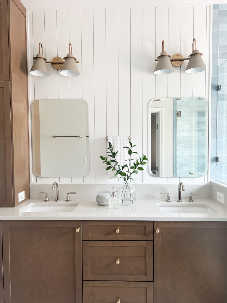 a bathroom with two sinks and a mirror